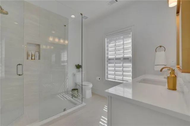 a bathroom with a granite countertop sink a bathtub and shower