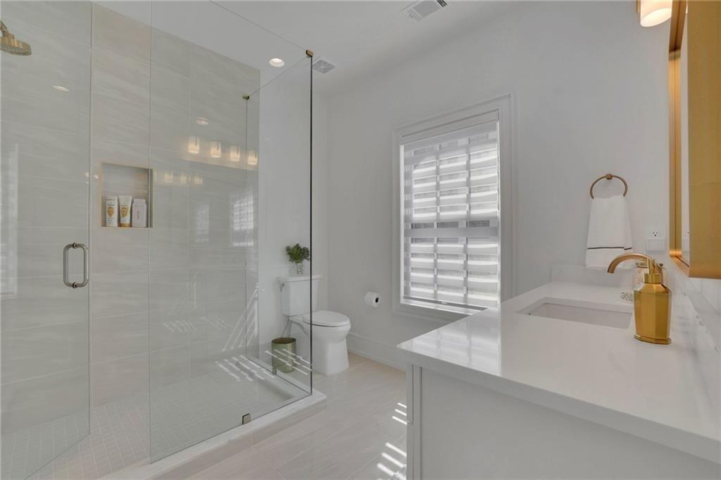 343 Sugarview Road Sugar Hill, GA 30518 - Photo 23 of 40 a bathroom with a granite countertop sink a bathtub and shower