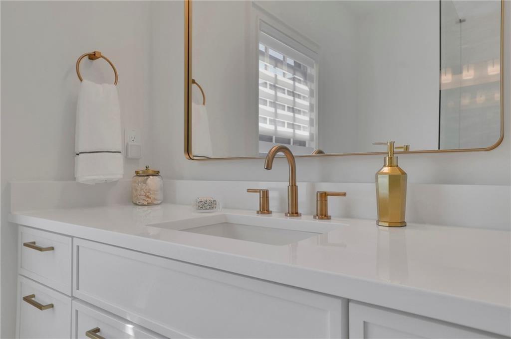 343 Sugarview Road Sugar Hill, GA 30518 - Photo 24 of 40 a bathroom with a sink and a mirror