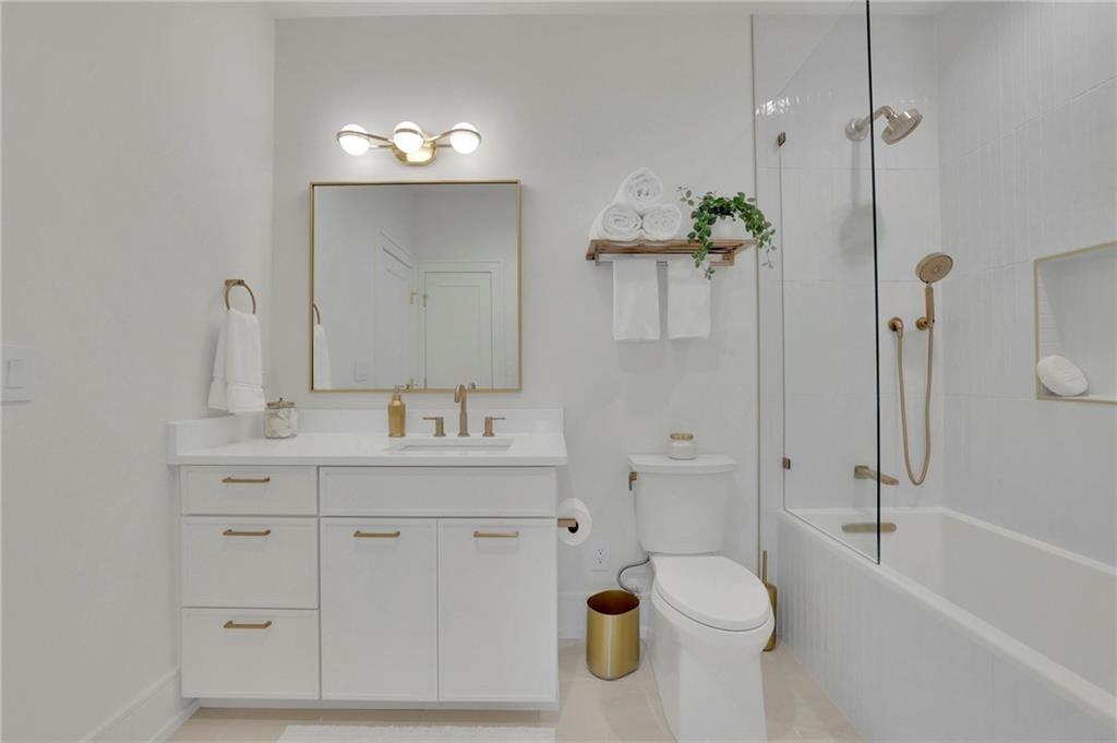 343 Sugarview Road Sugar Hill, GA 30518 - Photo 27 of 40 a bathroom with a granite countertop sink a toilet and shower
