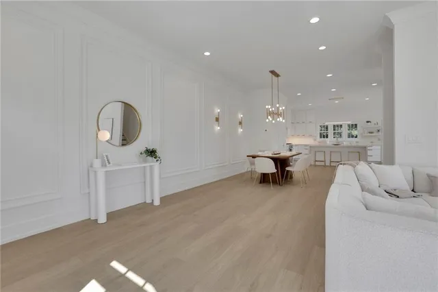 a living room with furniture and a chandelier