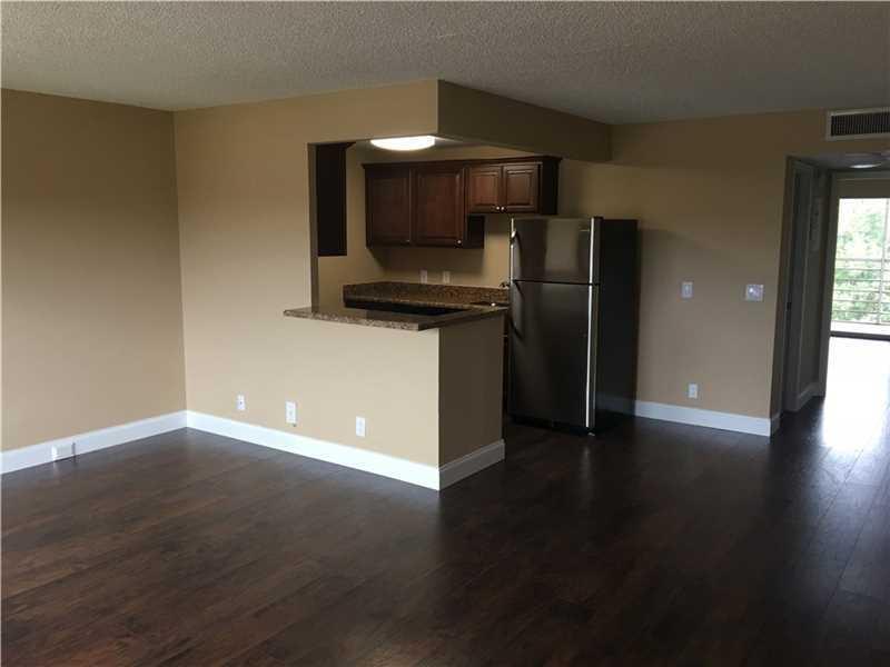 3014 Wolverton East, Unit A Boca Raton, FL 33434 - Photo 3 of 10 LIVING ROOM AND KITCHEN