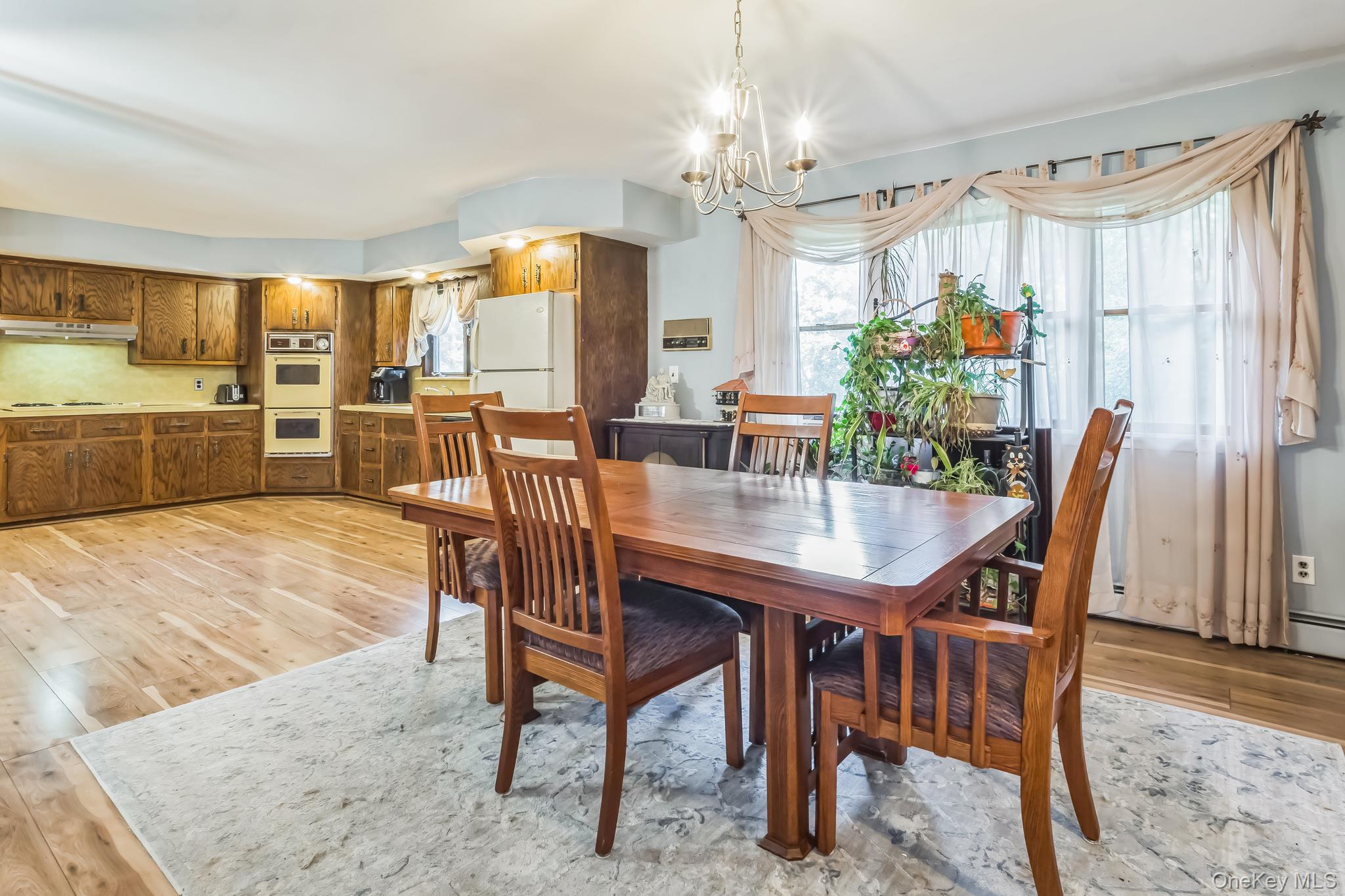 24 New Road Milton, NY 12547 - Photo 23 of 30 a dining room with furniture a chandelier and wooden floor