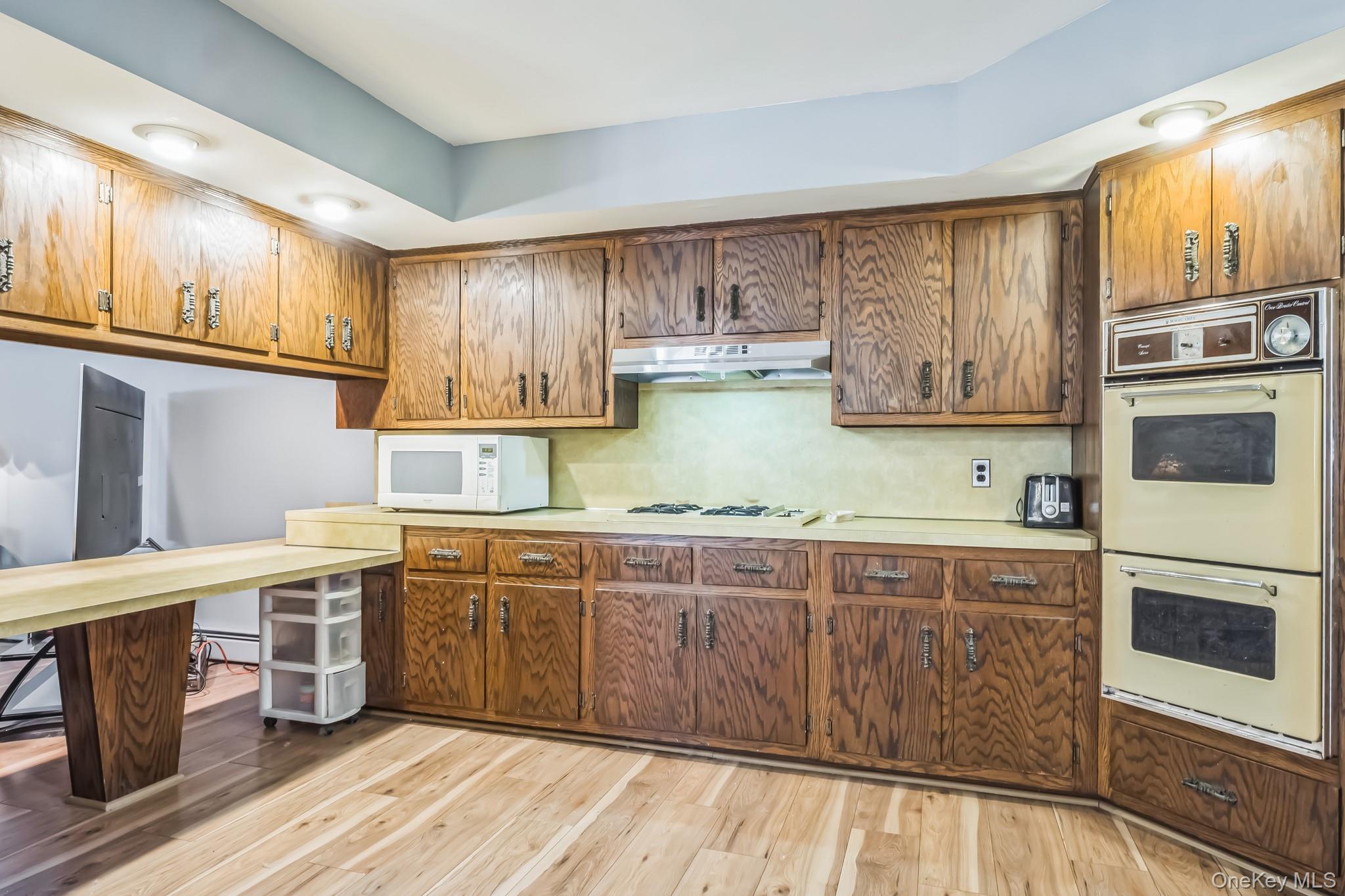 24 New Road Milton, NY 12547 - Photo 4 of 30 a kitchen with stainless steel appliances wooden cabinets and a stove top oven