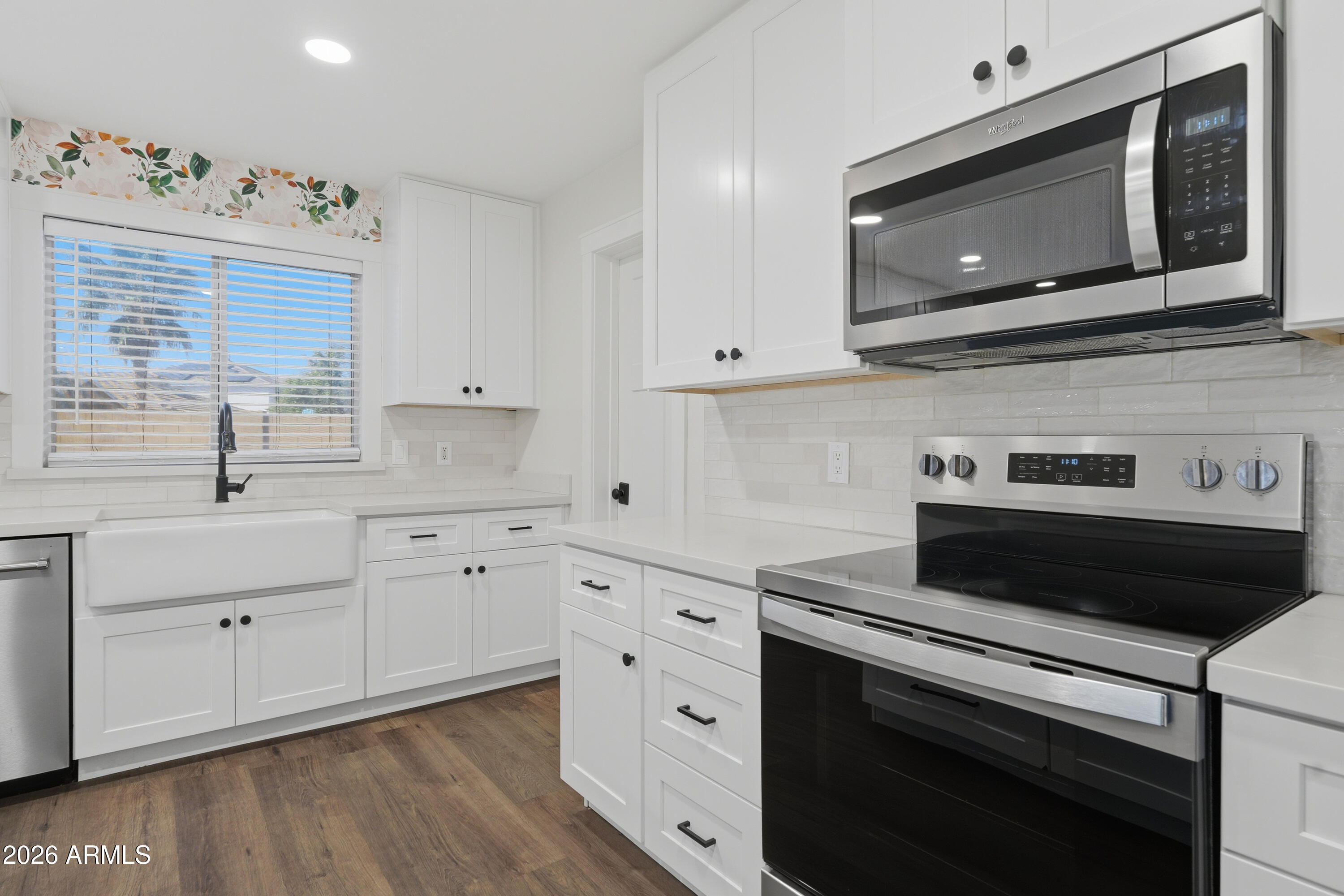 2497 East Ivanhoe Court Gilbert, AZ 85295 - Photo 11 of 57 a kitchen with cabinets stainless steel appliances and a window
