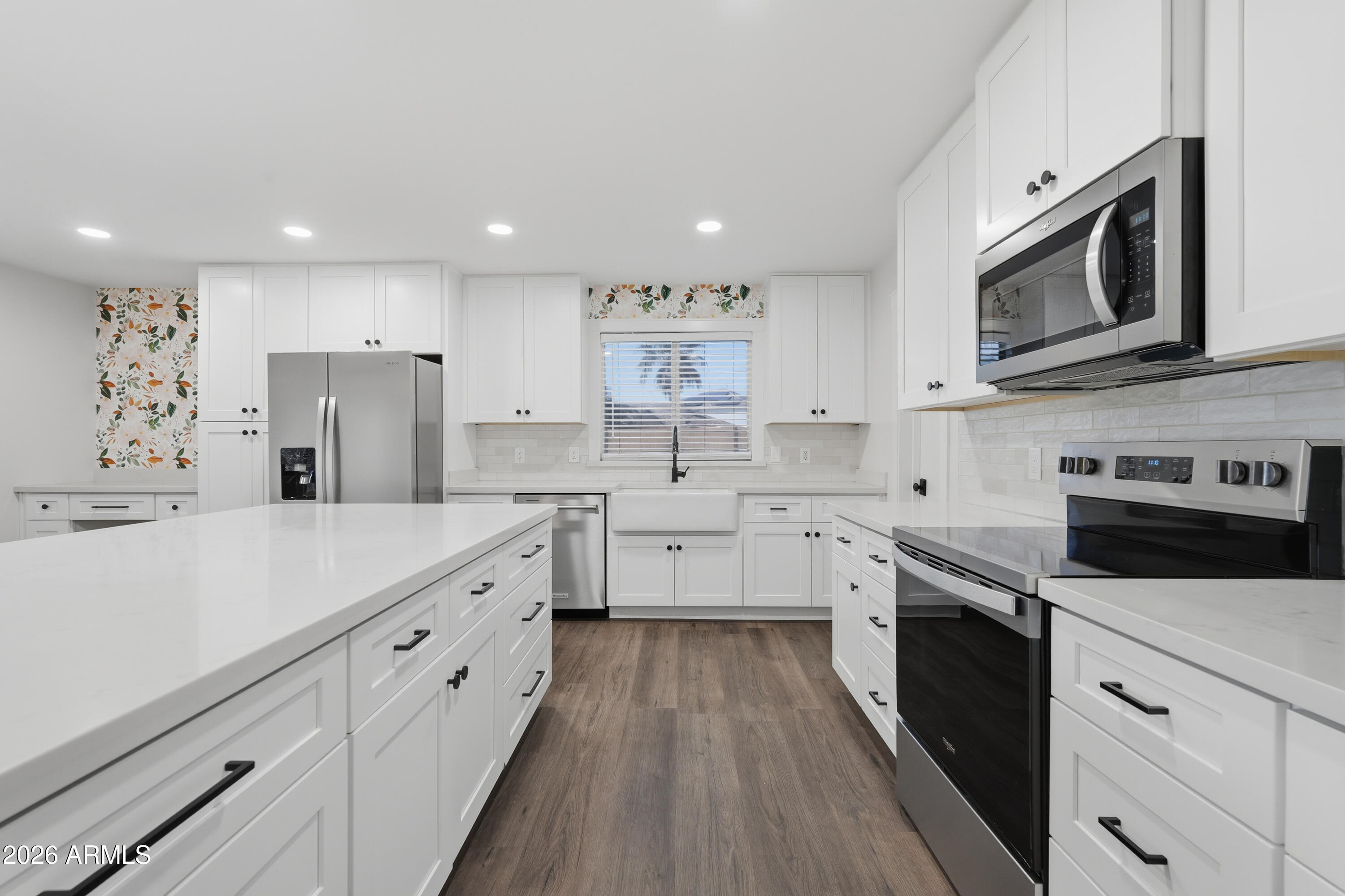 2497 East Ivanhoe Court Gilbert, AZ 85295 - Photo 12 of 57 a large kitchen with stainless steel appliances sink a microwave and cabinets