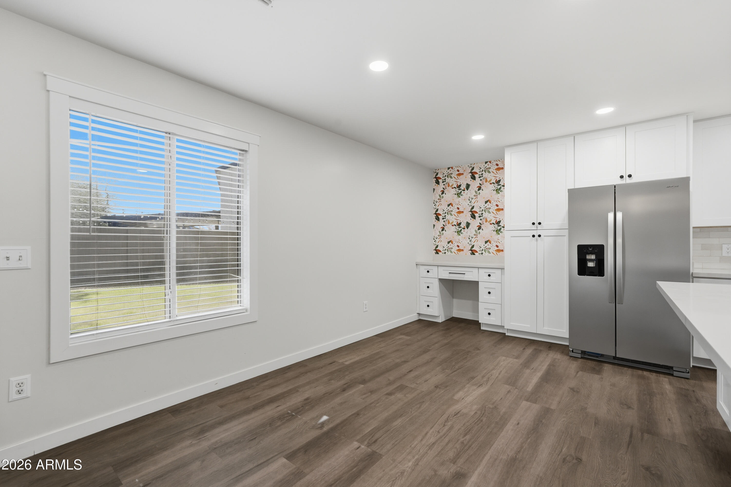 2497 East Ivanhoe Court Gilbert, AZ 85295 - Photo 13 of 57 a view of a kitchen with a refrigerator a ceiling fan and wooden floor