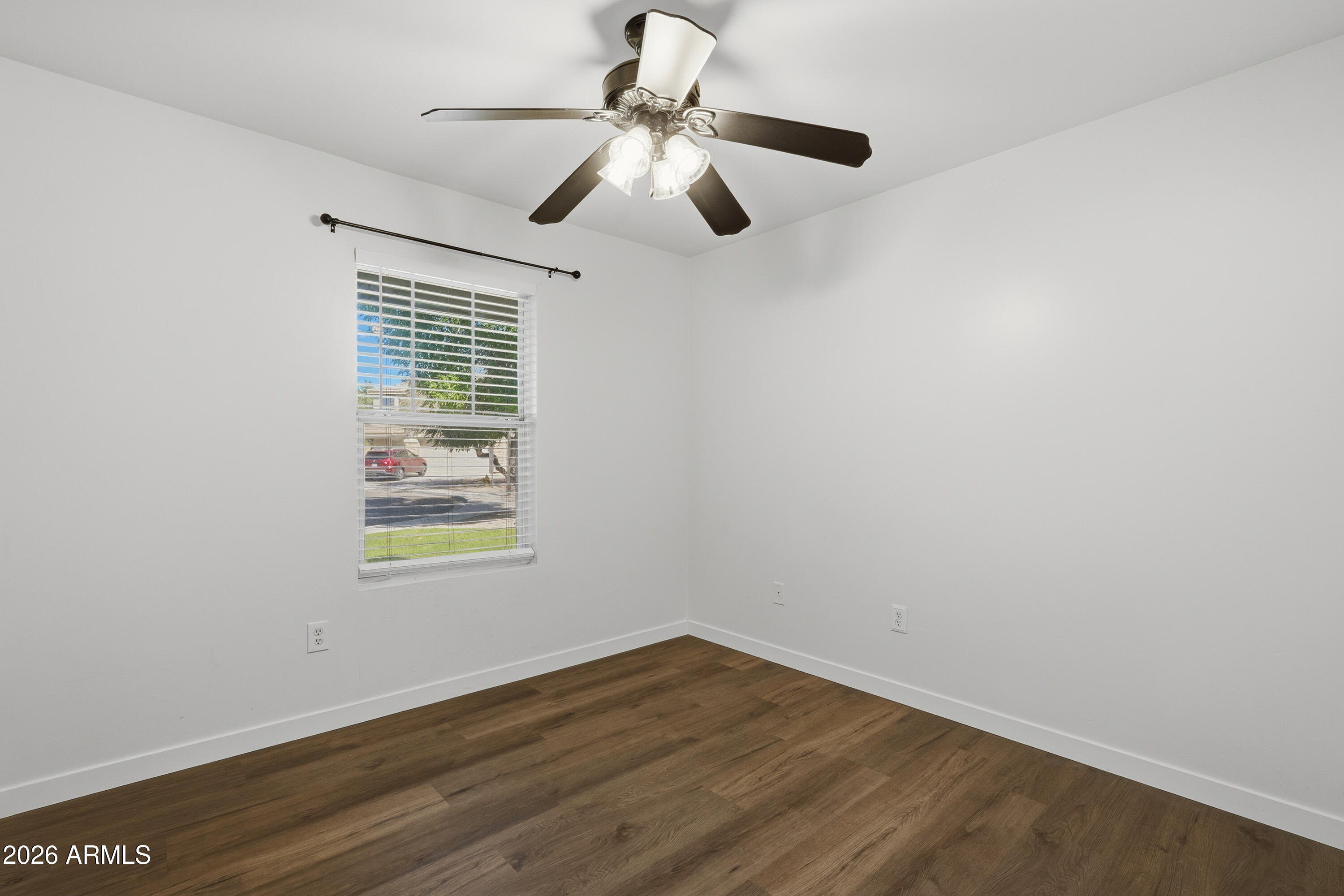 2497 East Ivanhoe Court Gilbert, AZ 85295 - Photo 14 of 57 a view of an empty room with wooden floor and a window