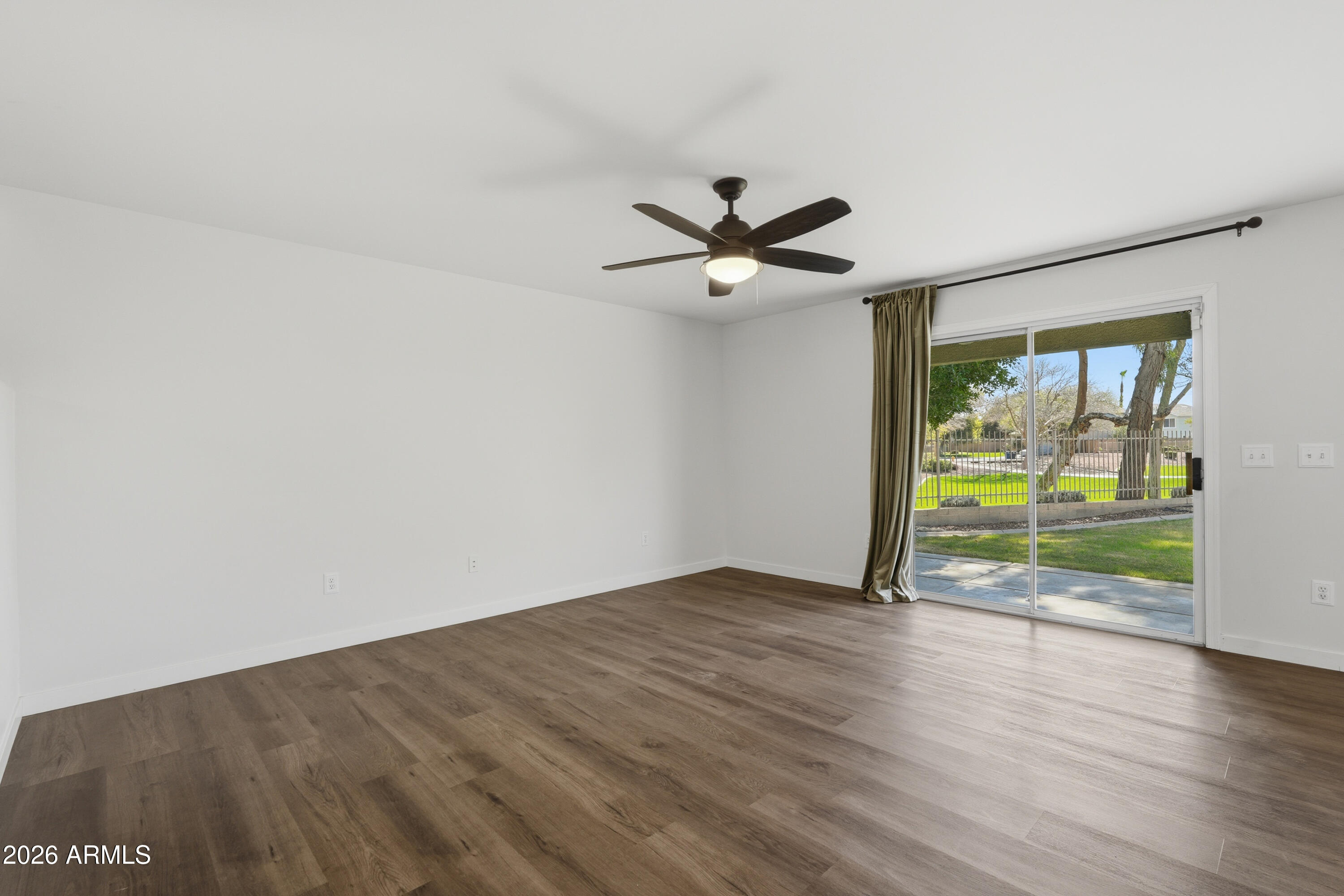 2497 East Ivanhoe Court Gilbert, AZ 85295 - Photo 16 of 57 an empty room with wooden floor and windows