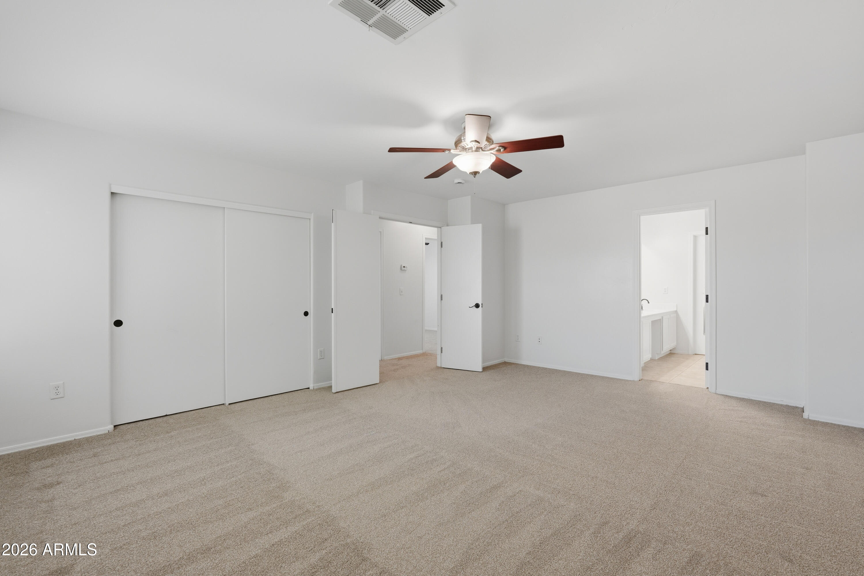 2497 East Ivanhoe Court Gilbert, AZ 85295 - Photo 28 of 57 a view of an empty room with a ceiling fan
