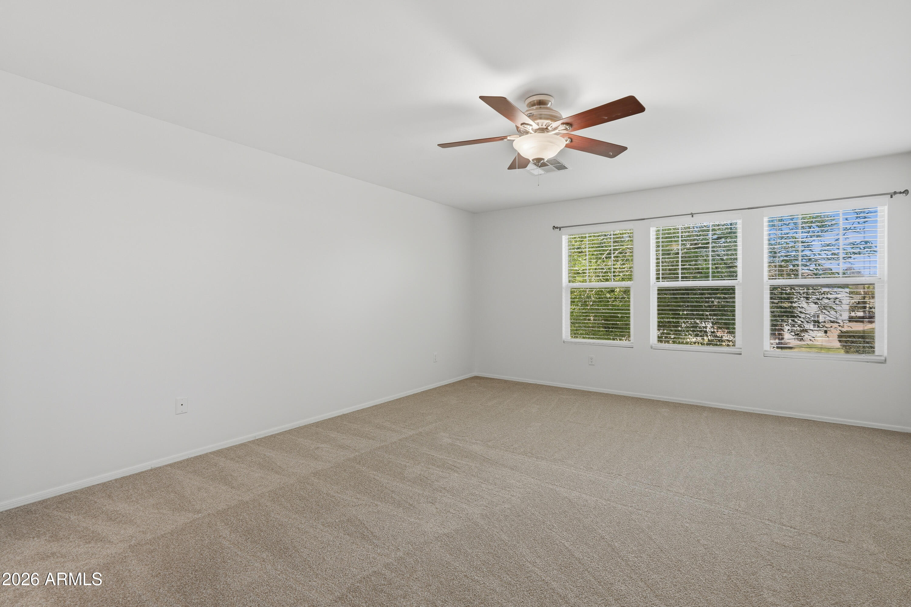 2497 East Ivanhoe Court Gilbert, AZ 85295 - Photo 29 of 57 an empty room with a window and a ceiling fan