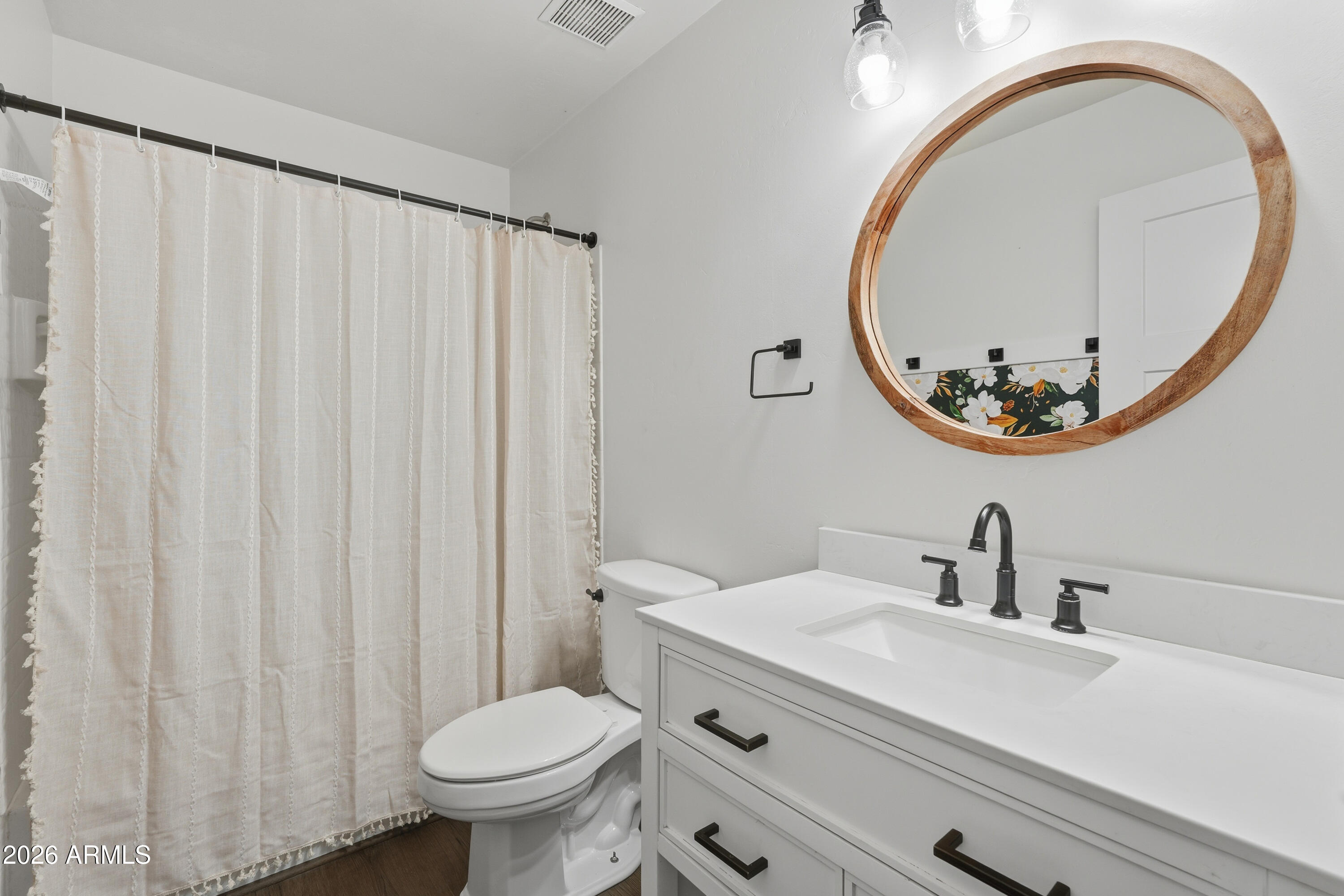 2497 East Ivanhoe Court Gilbert, AZ 85295 - Photo 32 of 57 a bathroom with a sink a mirror a toilet and a mirror