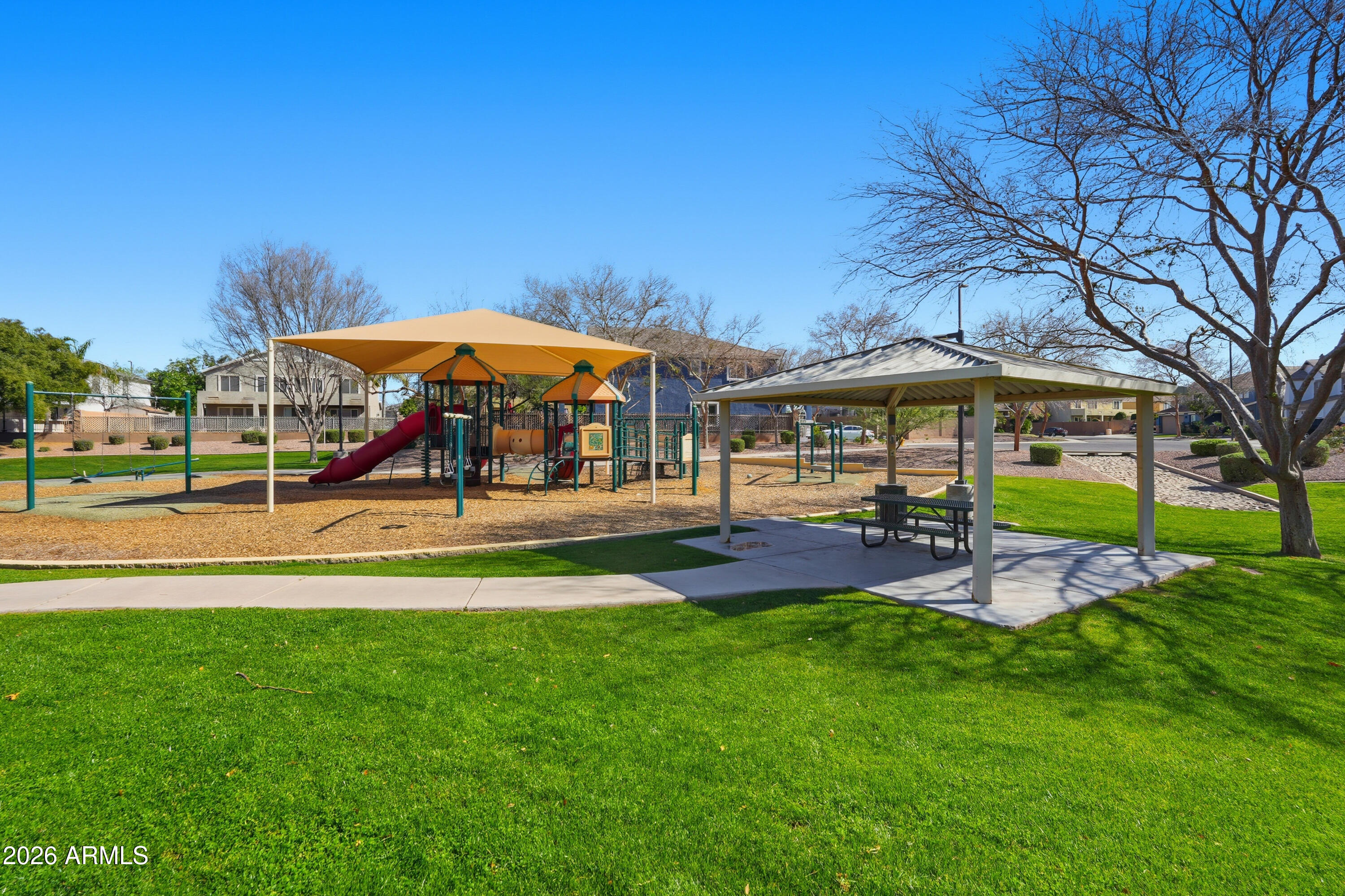 2497 East Ivanhoe Court Gilbert, AZ 85295 - Photo 54 of 57 a view of a swimming pool with lawn chairs under an umbrella