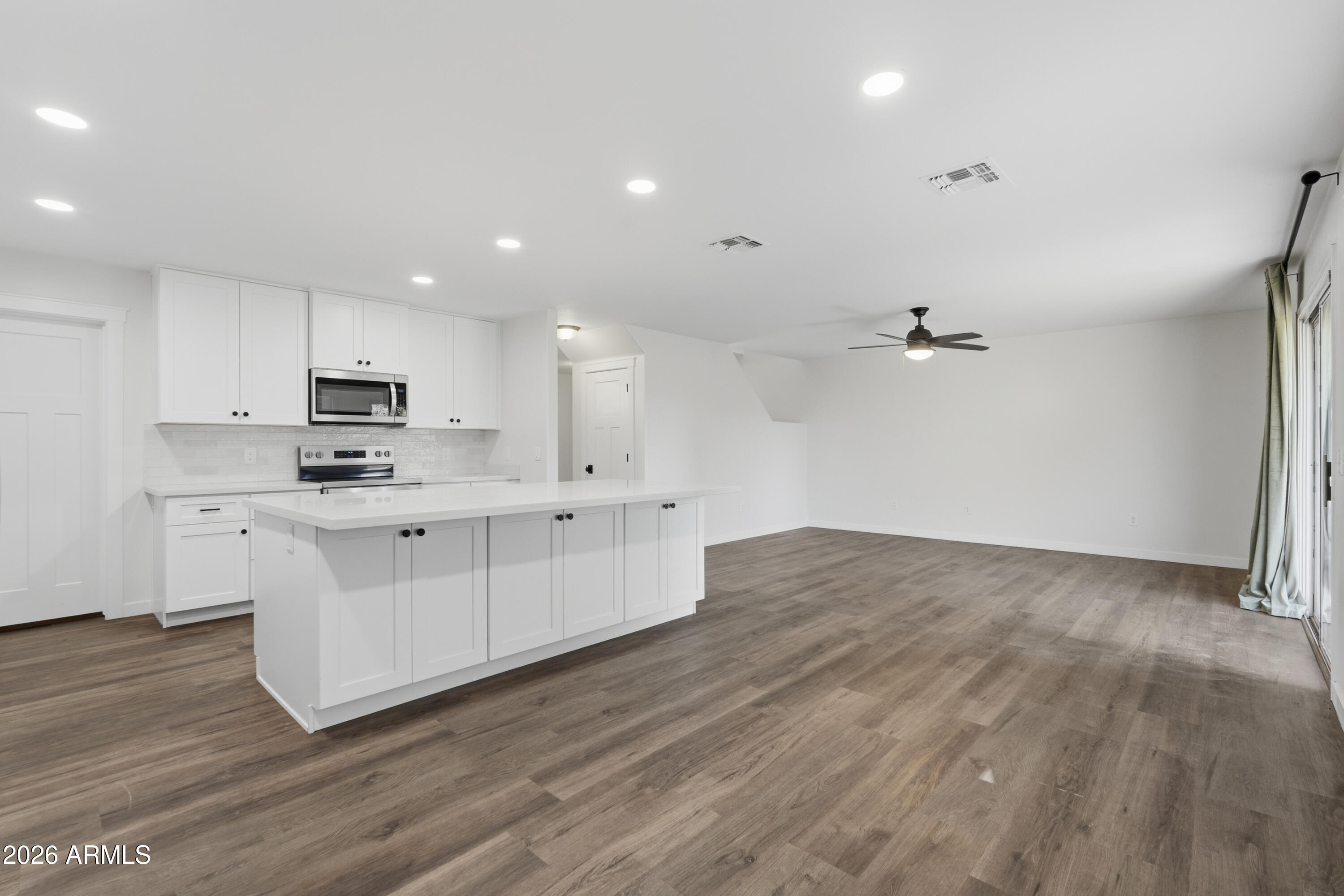2497 East Ivanhoe Court Gilbert, AZ 85295 - Photo 9 of 57 a kitchen with stainless steel appliances a refrigerator sink and microwave