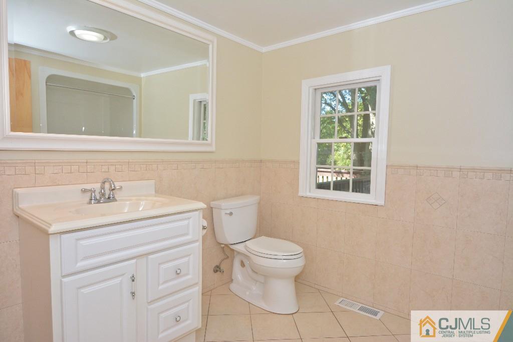 2 Taylor Road Princeton, NJ 08540 - Photo 14 of 25 a bathroom with a toilet a sink a mirror and a window
