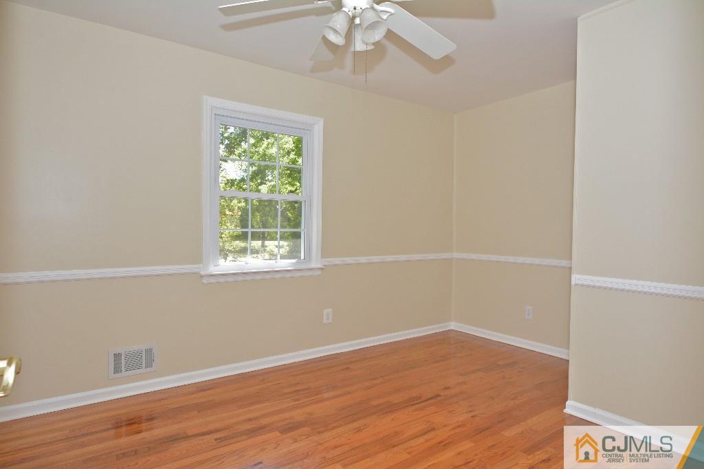 2 Taylor Road Princeton, NJ 08540 - Photo 15 of 25 an empty room with wooden floor and windows