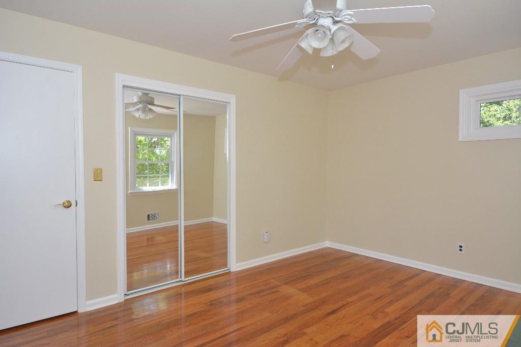2 Taylor Road Princeton, NJ 08540 - Photo 17 of 25 an empty room with wooden floor fan and windows