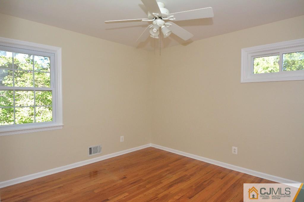 2 Taylor Road Princeton, NJ 08540 - Photo 18 of 25 an empty room with a window and wooden floor
