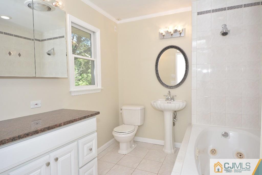 2 Taylor Road Princeton, NJ 08540 - Photo 23 of 25 a bathroom with a granite countertop toilet sink and mirror