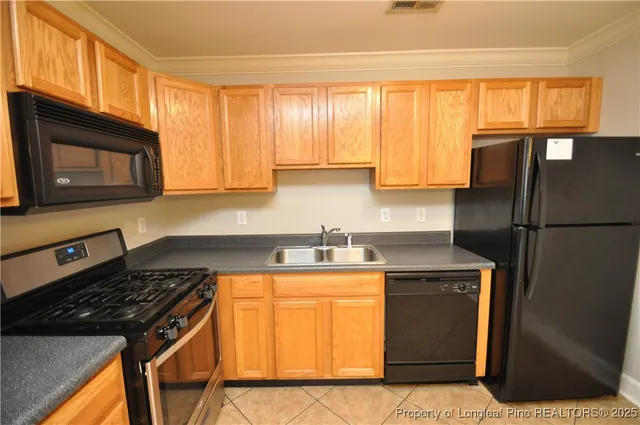 a kitchen with a stove a sink and a microwave