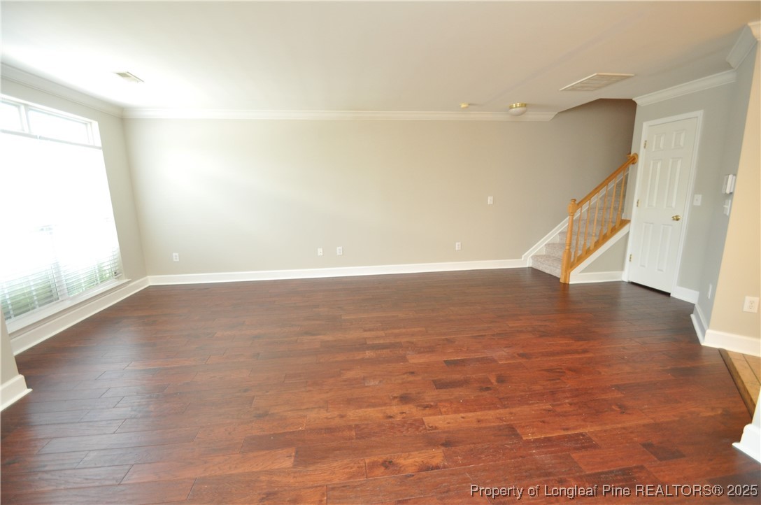 8600 Neuse Landing Lane, Unit 101 Raleigh, NC 27616 - Photo 13 of 29 a view of an empty room with wooden floor and a window