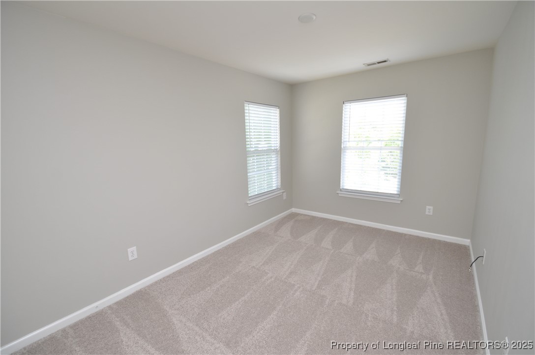 8600 Neuse Landing Lane, Unit 101 Raleigh, NC 27616 - Photo 16 of 29 an empty room with windows