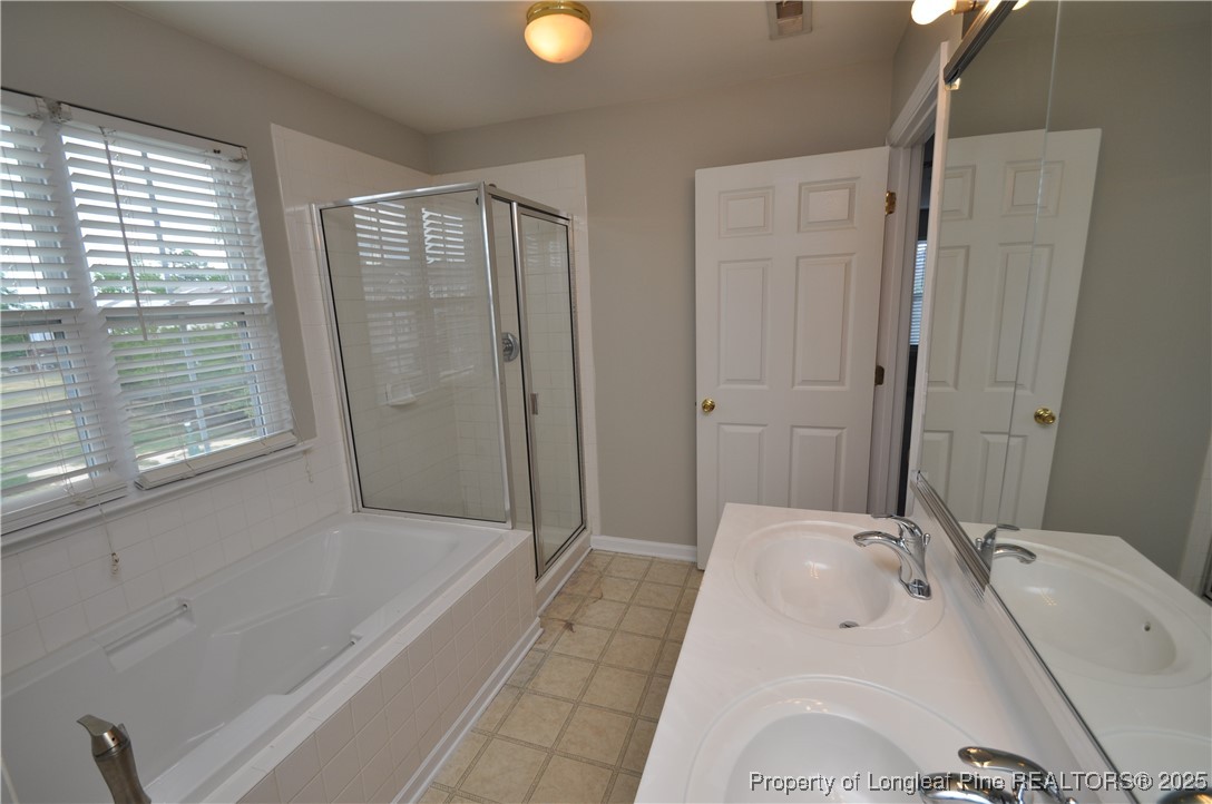 8600 Neuse Landing Lane, Unit 101 Raleigh, NC 27616 - Photo 21 of 29 a bathroom with a tub a sink and shower