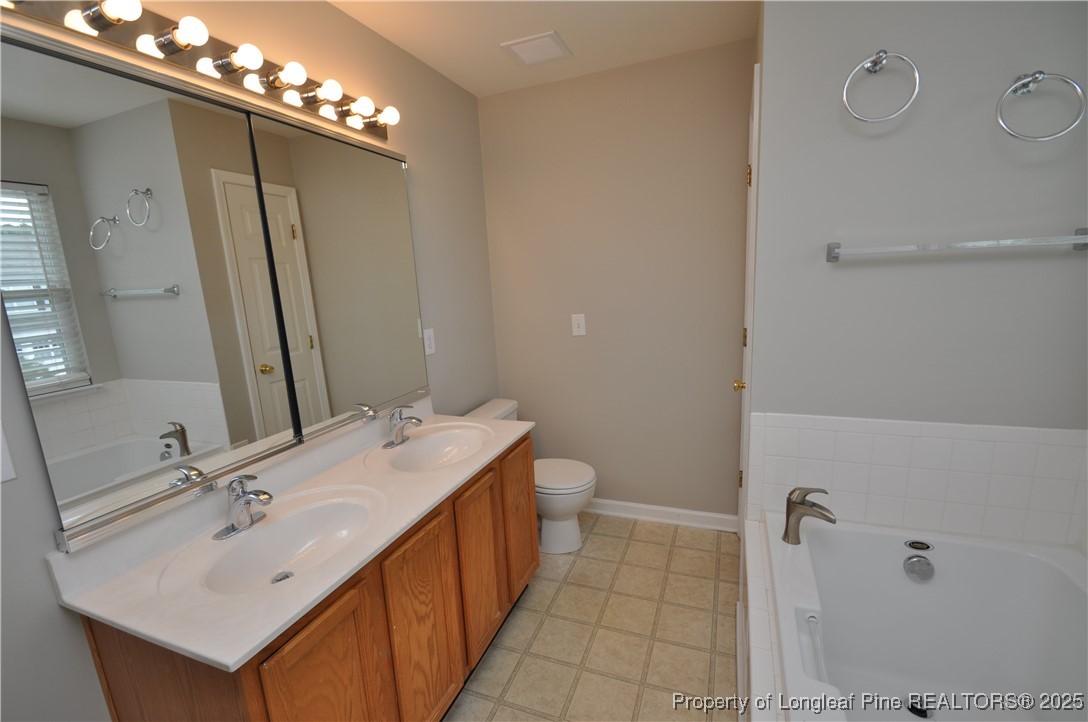 8600 Neuse Landing Lane, Unit 101 Raleigh, NC 27616 - Photo 22 of 29 a bathroom with a sink double vanity and a mirror