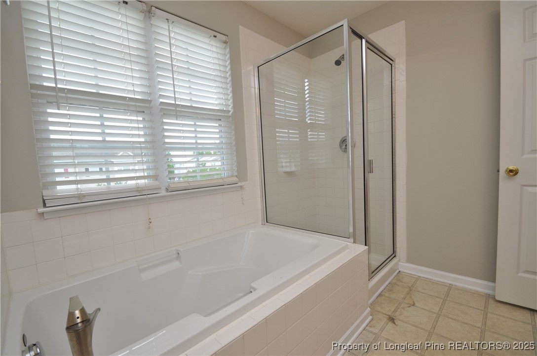 8600 Neuse Landing Lane, Unit 101 Raleigh, NC 27616 - Photo 23 of 29 a bathroom with a bathtub and a shower