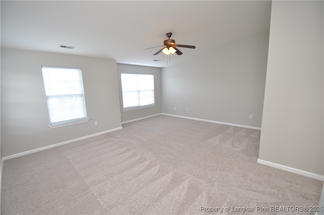 8600 Neuse Landing Lane, Unit 101 Raleigh, NC 27616 - Photo 24 of 29 an empty room with windows and fan
