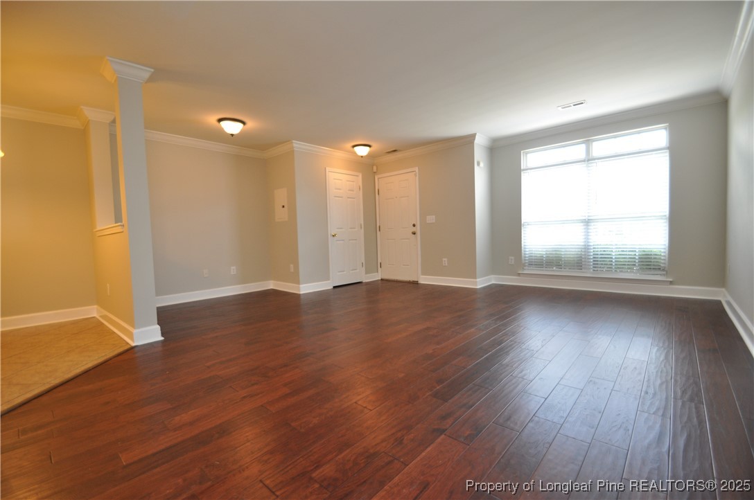 8600 Neuse Landing Lane, Unit 101 Raleigh, NC 27616 - Photo 4 of 29 an empty room with wooden floor and windows
