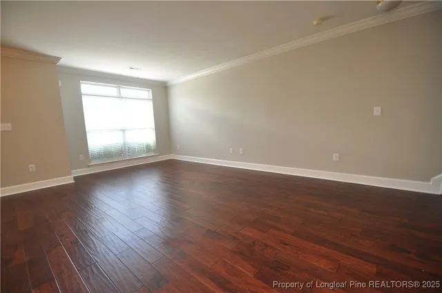 a view of wooden floor and windows in an empty room