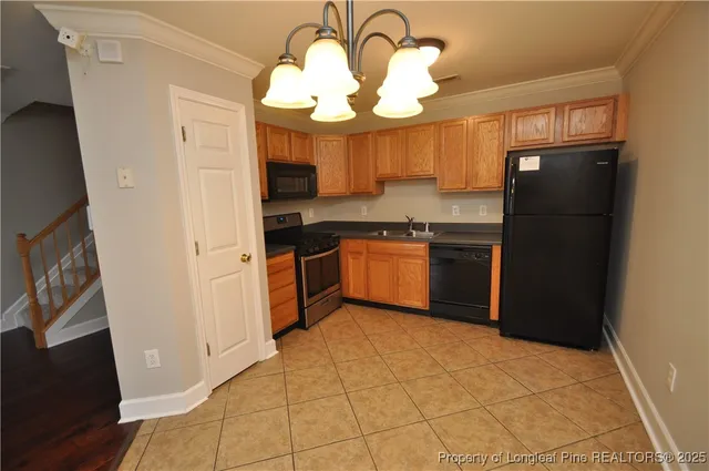 a kitchen with stainless steel appliances granite countertop a refrigerator a sink a stove and island