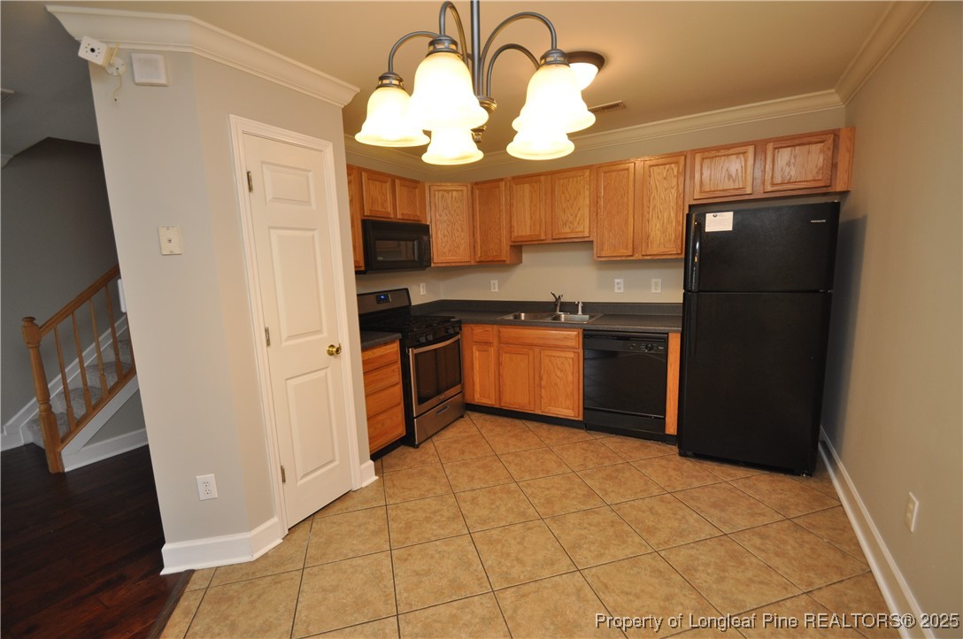 8600 Neuse Landing Lane, Unit 101 Raleigh, NC 27616 - Photo 8 of 29 a kitchen with stainless steel appliances granite countertop a refrigerator a sink a stove and island