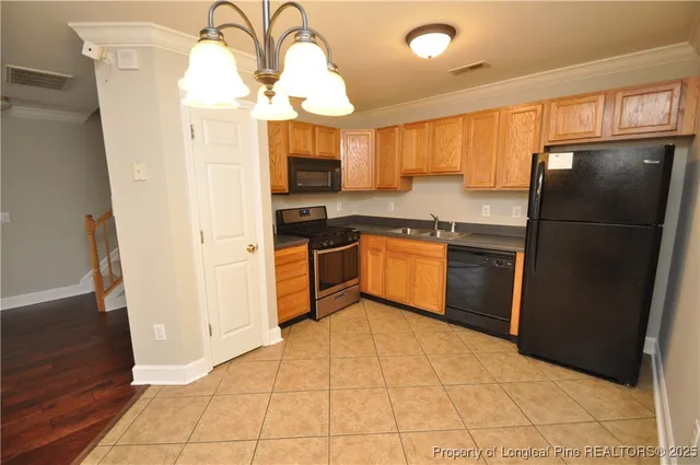 a kitchen with stainless steel appliances granite countertop a refrigerator a sink a stove with wooden floor and cabinets