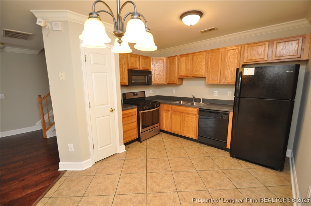8600 Neuse Landing Lane, Unit 101 Raleigh, NC 27616 - Photo 9 of 29 a kitchen with stainless steel appliances granite countertop a refrigerator a sink a stove with wooden floor and cabinets