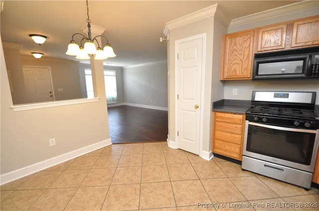 a view of a kitchen with a stove cabinets and a floor to ceiling window