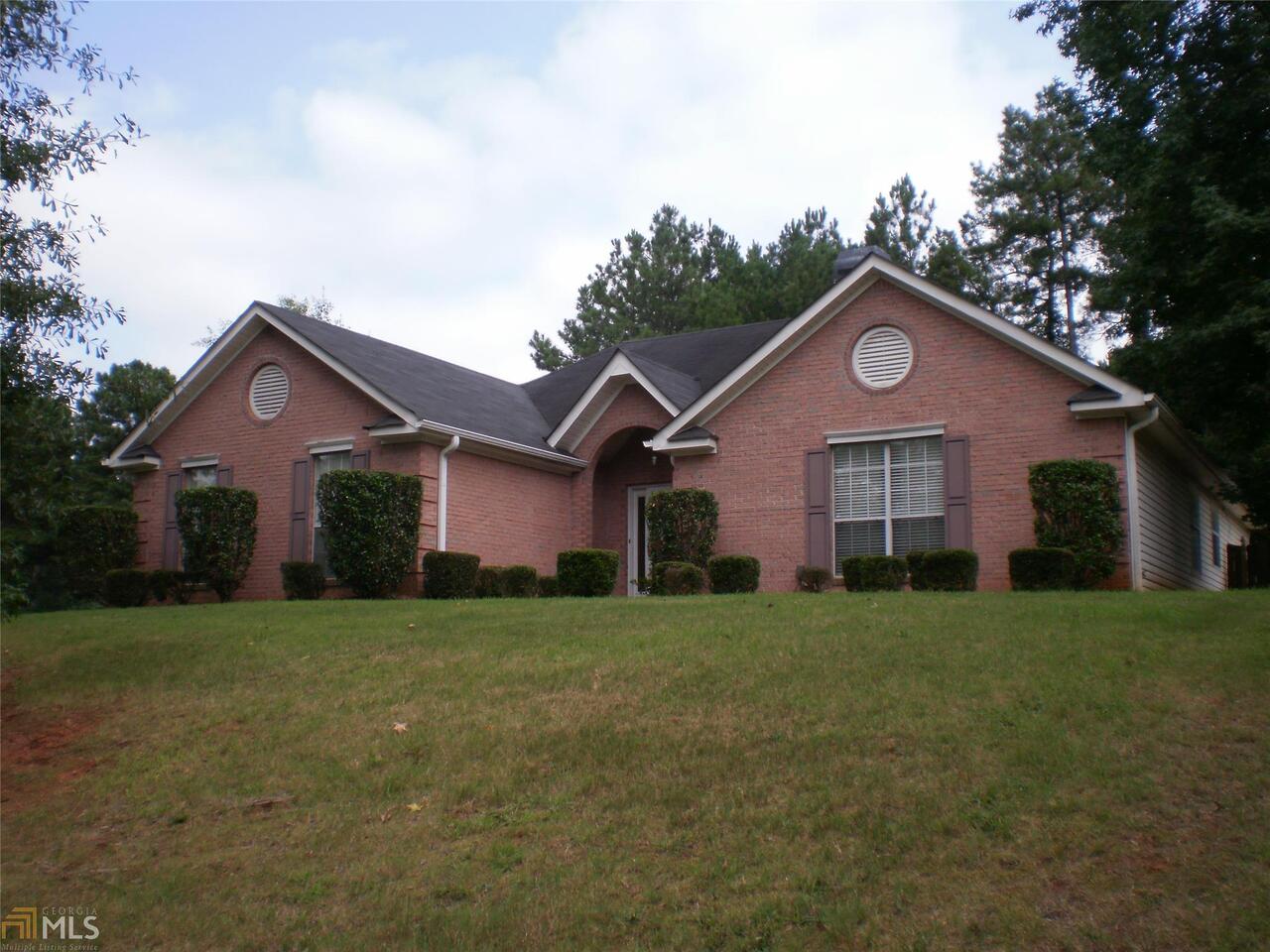 51 Rosedale Trace, Unit 14 Hampton, GA 30228 - Photo 1 of 1 a front view of a house with a yard