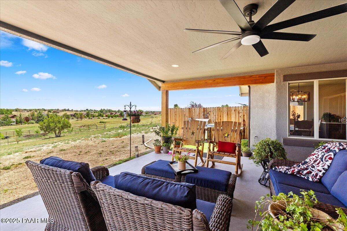 1617 Windmill Way Chino Valley, AZ 86323 - Photo 26 of 42 a living room with furniture floor to ceiling window and a flat screen tv