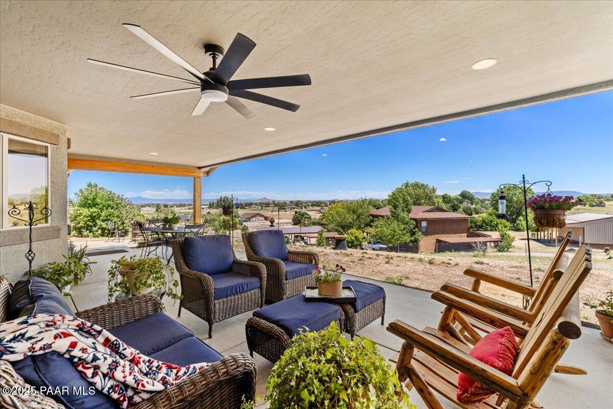 1617 Windmill Way Chino Valley, AZ 86323 - Photo 27 of 42 a living room with furniture and a floor to ceiling window