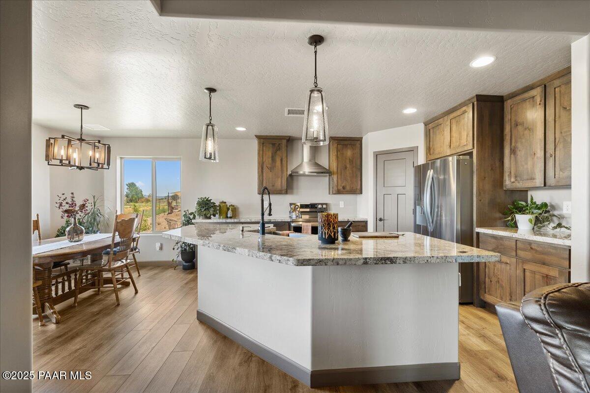 1617 Windmill Way Chino Valley, AZ 86323 - Photo 10 of 42 a view of kitchen with stainless steel appliances granite countertop a sink dishwasher a refrigerator and cabinets with wooden floor