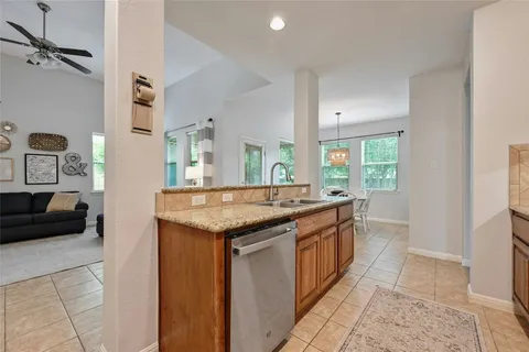 a kitchen with granite countertop a sink and a stove
