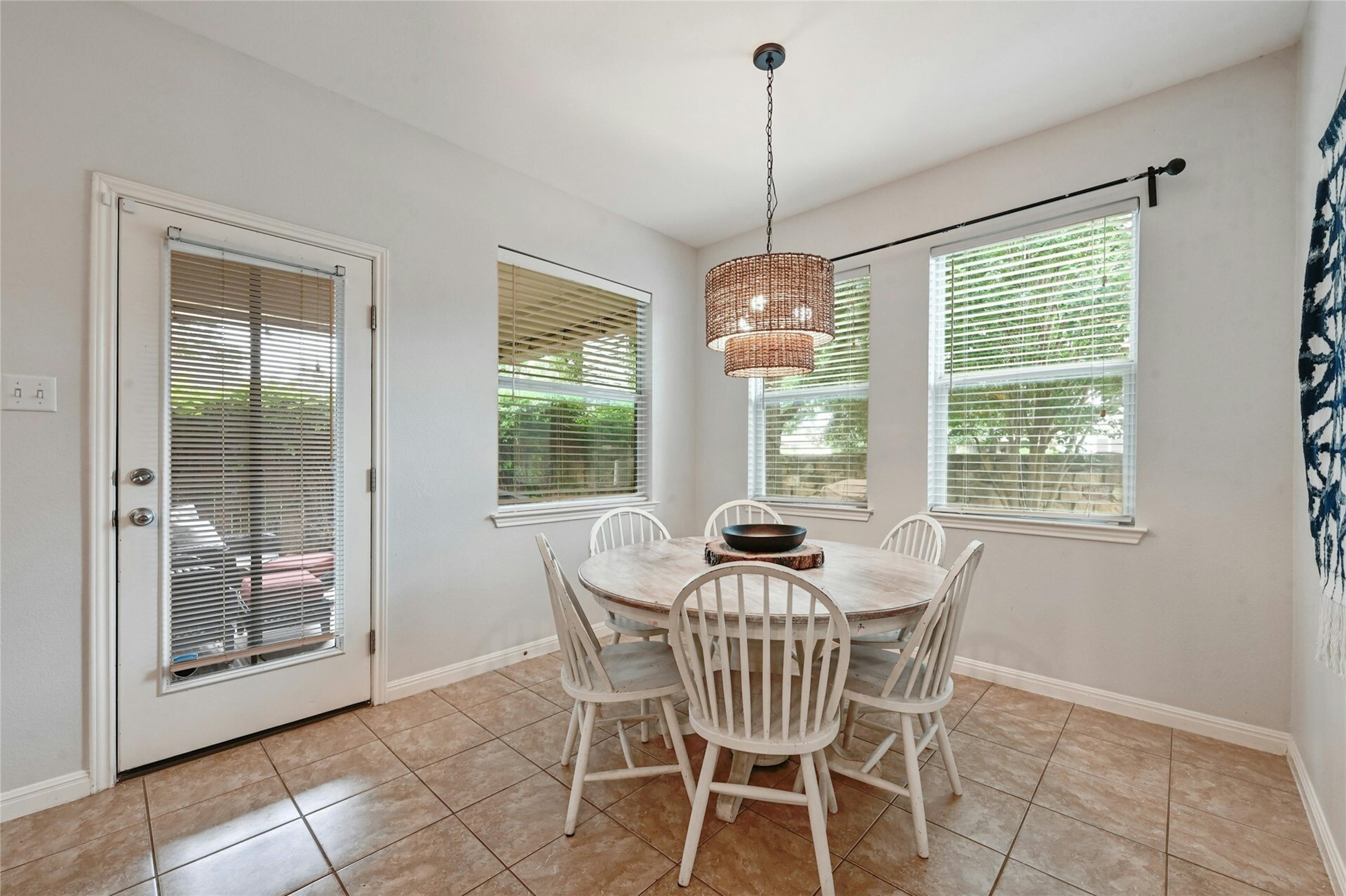 130 Farm House Road San Marcos, TX 78666 - Photo 11 of 34 a dining room with furniture large windows and a chandelier