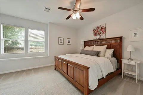 a large bed sitting in a bedroom next to a window