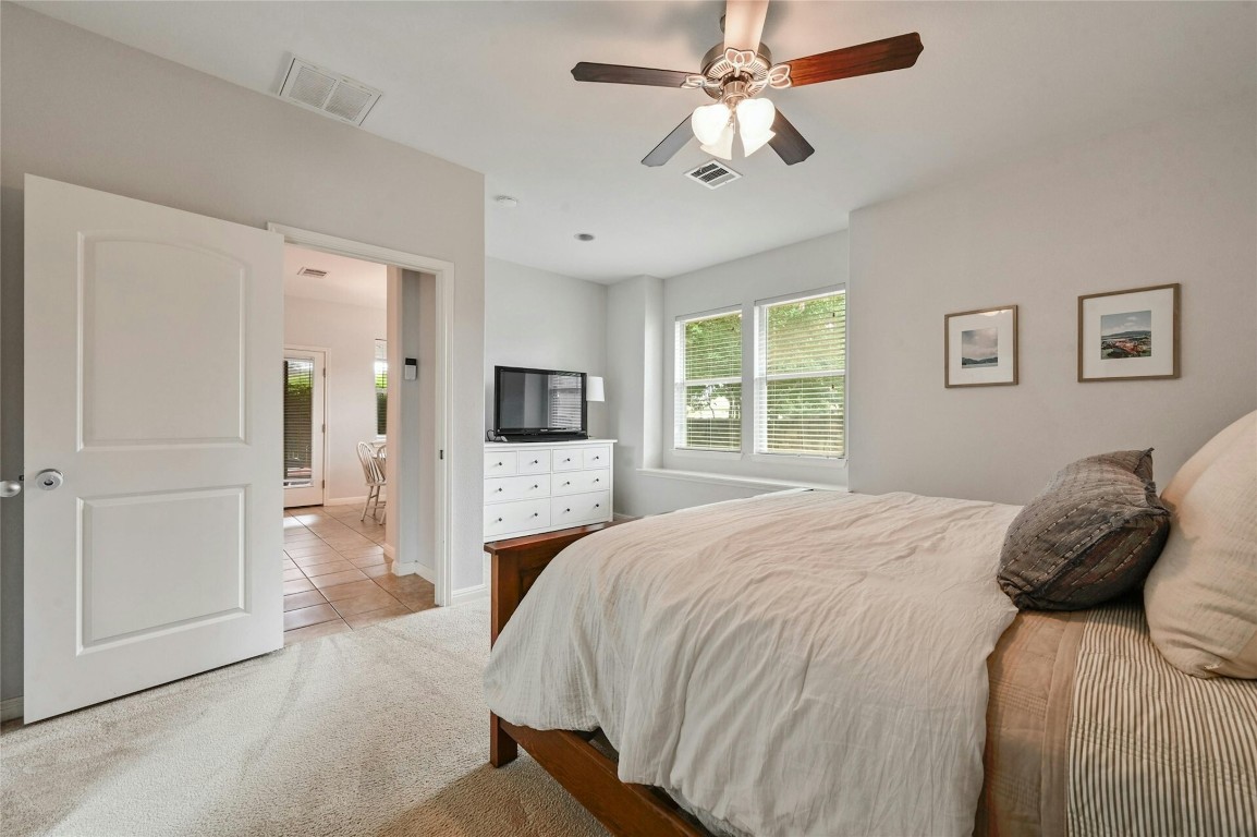 130 Farm House Road San Marcos, TX 78666 - Photo 16 of 35 a bedroom with a bed and a flat screen tv