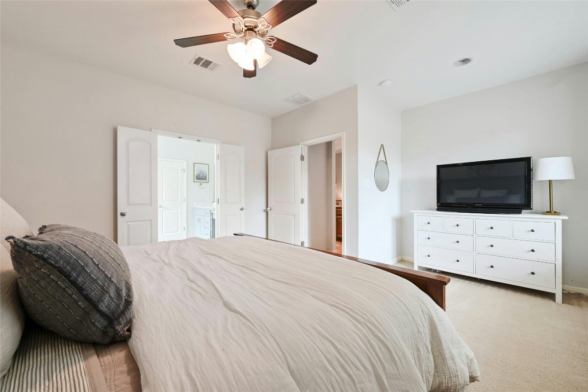 130 Farm House Road San Marcos, TX 78666 - Photo 17 of 35 a bedroom with a bed and a flat screen tv