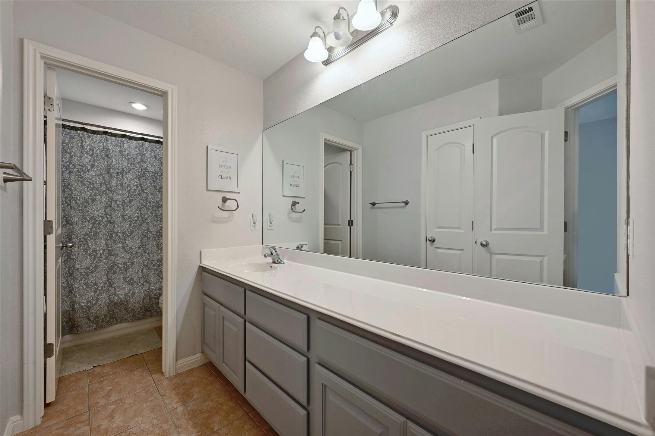 130 Farm House Road San Marcos, TX 78666 - Photo 24 of 34 a bathroom with a sink a large mirror and a shower