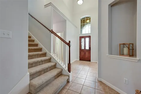 a view of staircase and hallway with wooden floor
