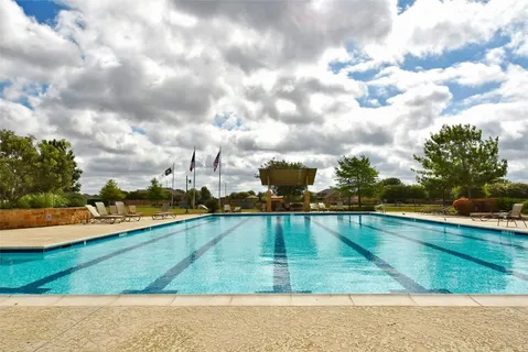 a view of a swimming pool and an outdoor seating