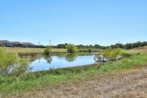 a view of a lake view with houses in back
